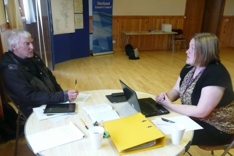 Peter Brown, of Ollaberry, discusses the Northmavine bus service with transport strategy officer Elaine Park. Pic. Shetnews