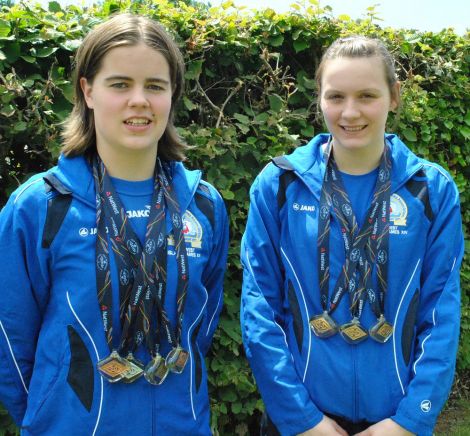 Shetland swimmers Amy Harper (left) and Andrea Strachan with some of their medals won at the 2011 NatWest Island Games, held in the Isles of Wight.