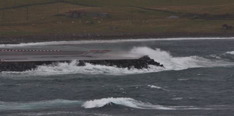 Waves batter the runway extension at Sumburgh during last Sunday's easterly winds, which the current repairs are designed to withstand. Photo Ronnie Robertson