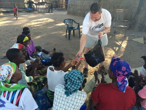Mark Wylie handing out wind-up torches which will enable adults to attend medical services after darkness - Photo: Team Malawi