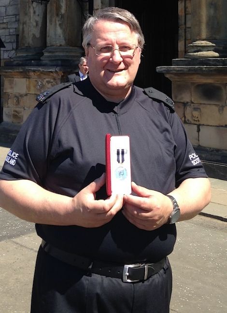 Special constable Peter Smith with his Queen's Police Medal outside Holyrood Palace on Tuesday.