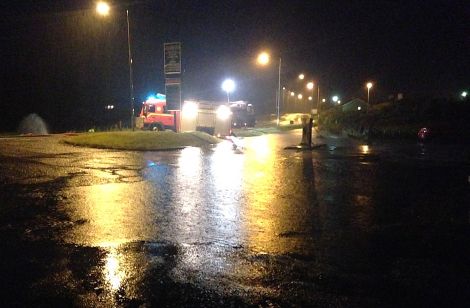 Fire crews pumping water from the old Adamson Brothers building in Cunningsburgh - Photo: Michael Owen
