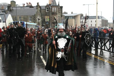 Guizer Jarl Neil Robertson are greeted by onlookers at Victoria Pier on Tuesday morning. Photo: Toby Sandison