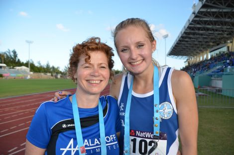 All smiles in Bermuda two years ago – athletics team manager Karen Woods with athlete Emma Leask, who won gold in the Women’s 800 metre race for the third consecutive Games. Photo courtesy of SIGA