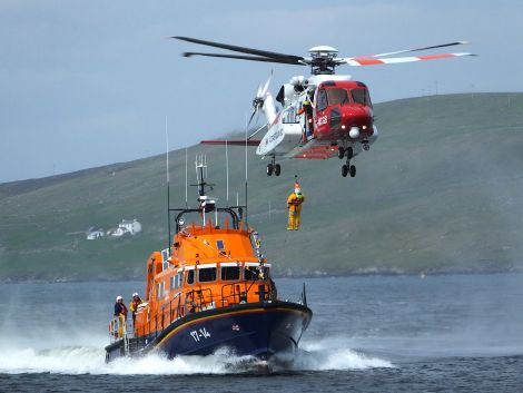 The coastguard helicopter is regularly seen exercising with Shetland's two life boats. Seen here is the Aith lifeboat, the Charles Lidbury - Photo: Bristow
