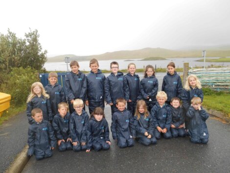 Pupils from Nesting Primary School try out their new waterproof walking kit - provided by Scottish Sea Farms.