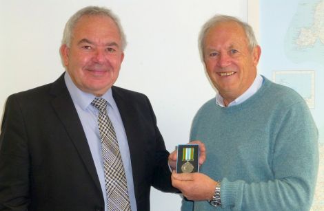 Head of laboratory services at NHS Shetland Geoff Day receiving the Ebola medal from chairman of NHS Shetland Ian Kinniburgh - Photo: NHS Shetland