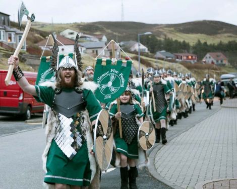 Enjoying every minute, Jarl Haakon Haraldsson leads his squad of Vikings through the streets of Scalloway on a cold but clear Friday morning. All photos Garry Sandison
