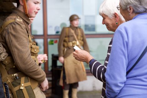 When approached, the men and boys said nothing. Instead they handed out cards with the identity of a soldier who died on the first day of the battle that took place exactly 100 years ago.