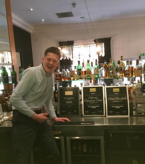 Delighted duty manager Jonny Sandison proudly displaying Scalloway Hotel's three awards.