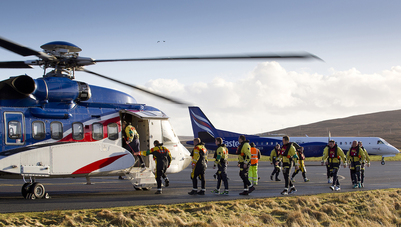 Offshore workers boarding a Bristow operated helicopter at Scatsta.