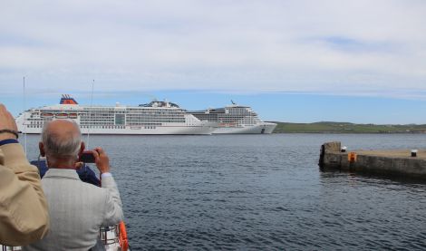 The Europa 2 leaving Lerwick Harbour at around 2pm on Tuesday while the much larger cruse ship MSC Meraviglia is still anchored in Bressay Sound. Photo: Hans J Marter/Shetland News