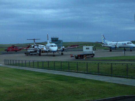 A group of planes parked on a tarmac.