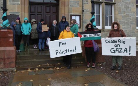 Group of people holding signs advocating for palestine and a ceasefire on gaza.