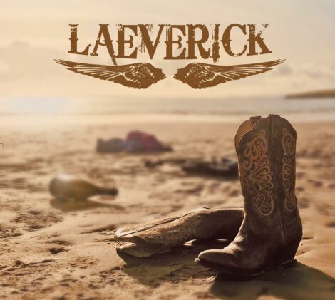 A pair of cowboy boots on the beach with the words laverrick.