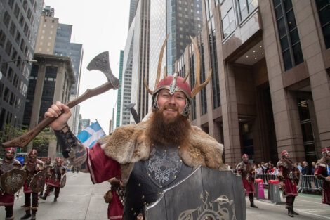 A man dressed as a viking holding an axe.