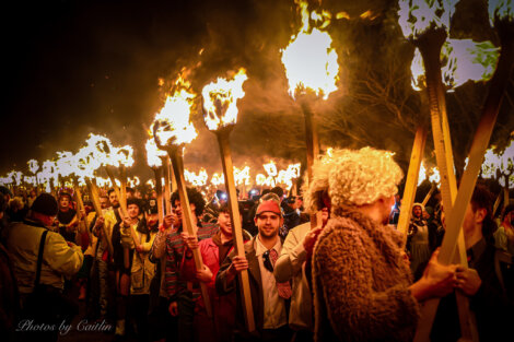 A group of people holding fire torches.