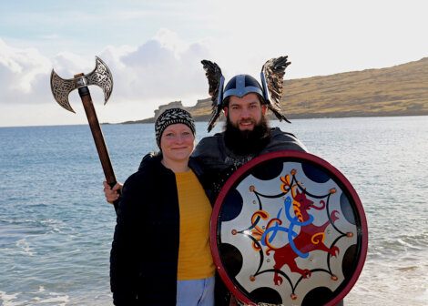 A man and woman wearing viking clothing.