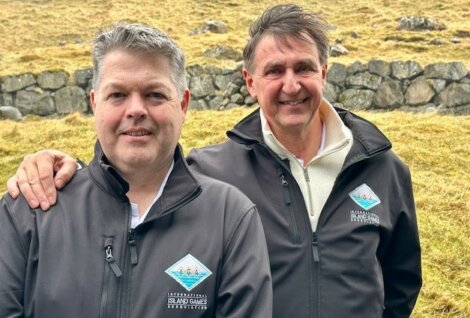 Two men in matching jackets branded with 